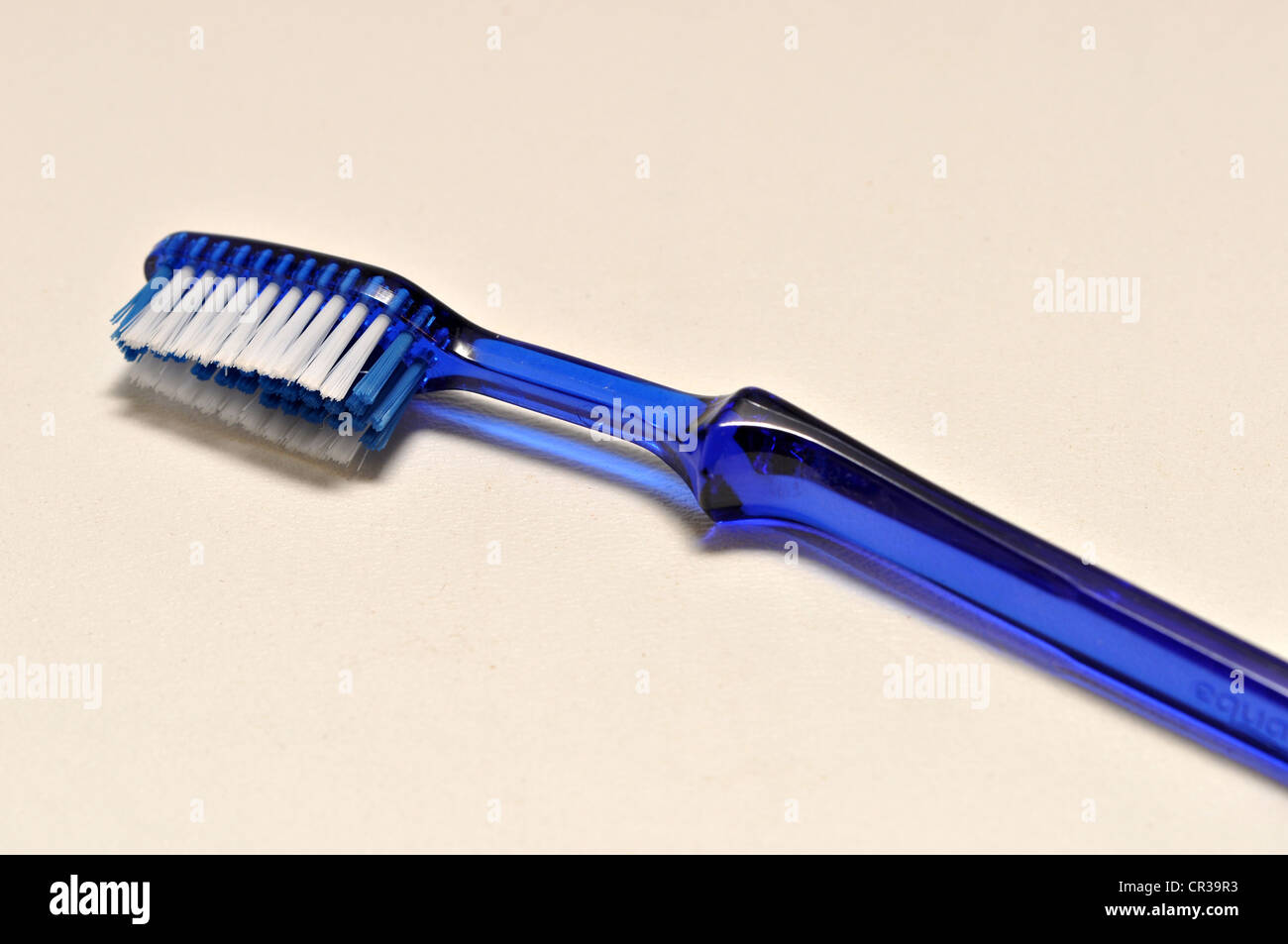 A single blue tooth brush lies on a white background Stock Photo - Alamy