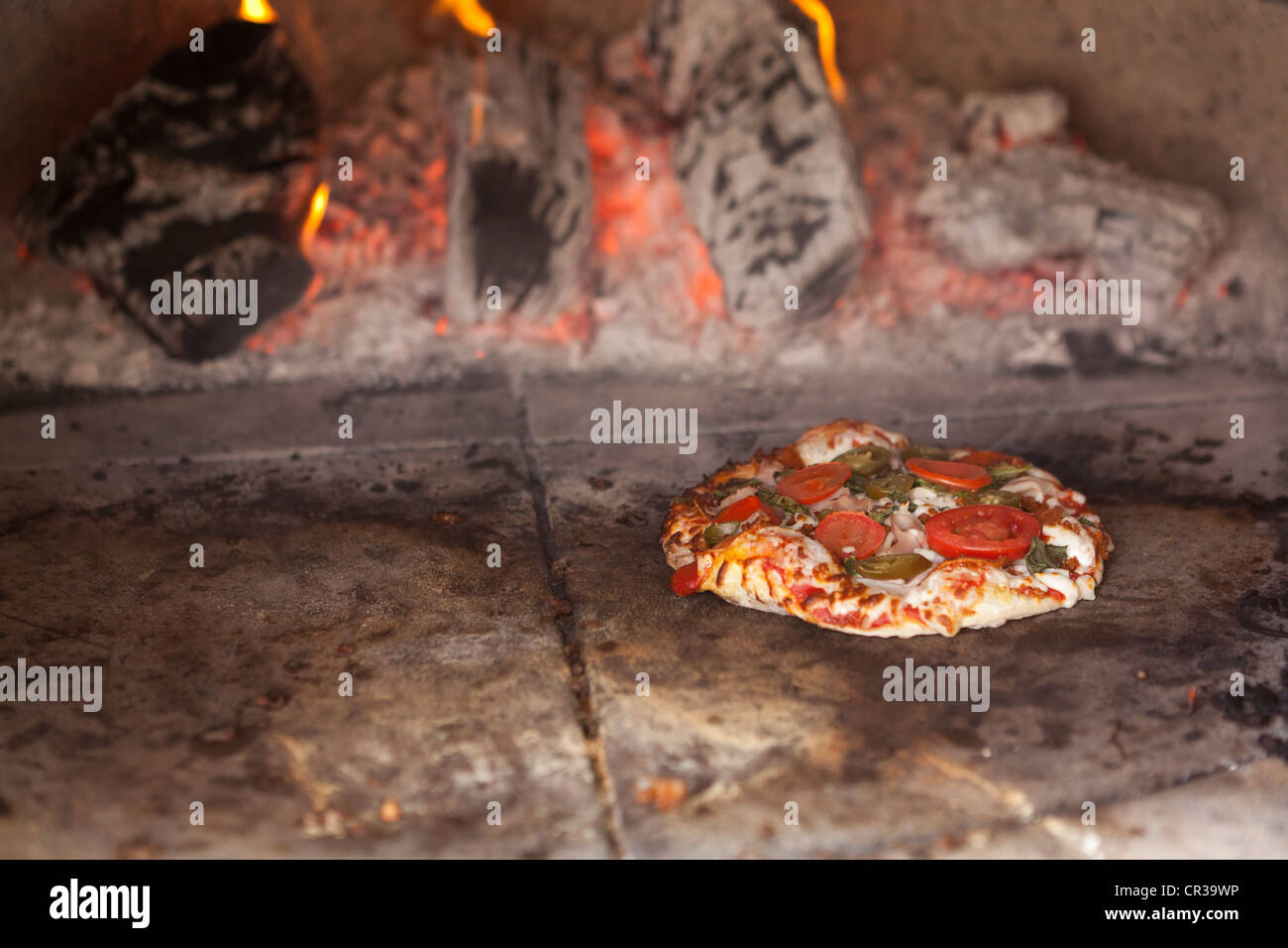 Small pizza in stone oven Stock Photo