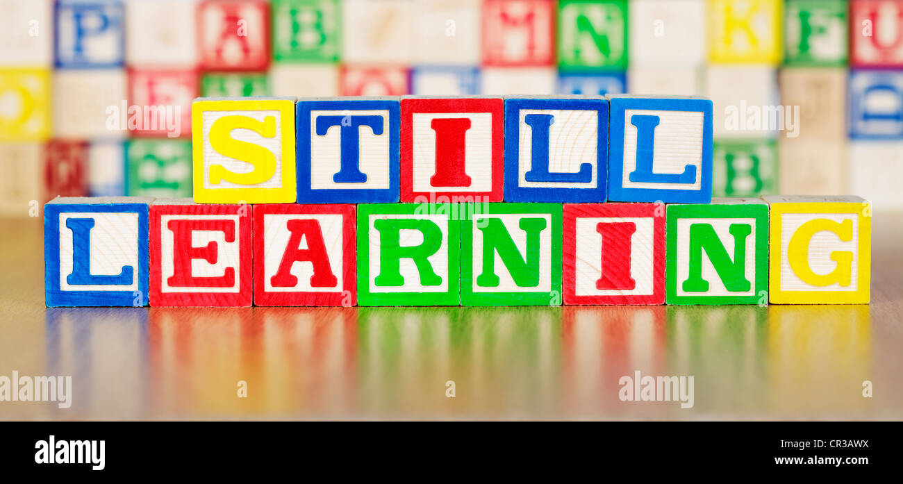 Still Learning Spelled Out in Alphabet Building Blocks Stock Photo