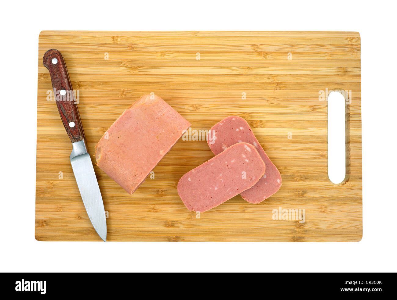Luncheon meat sliced on cutting board Stock Photo