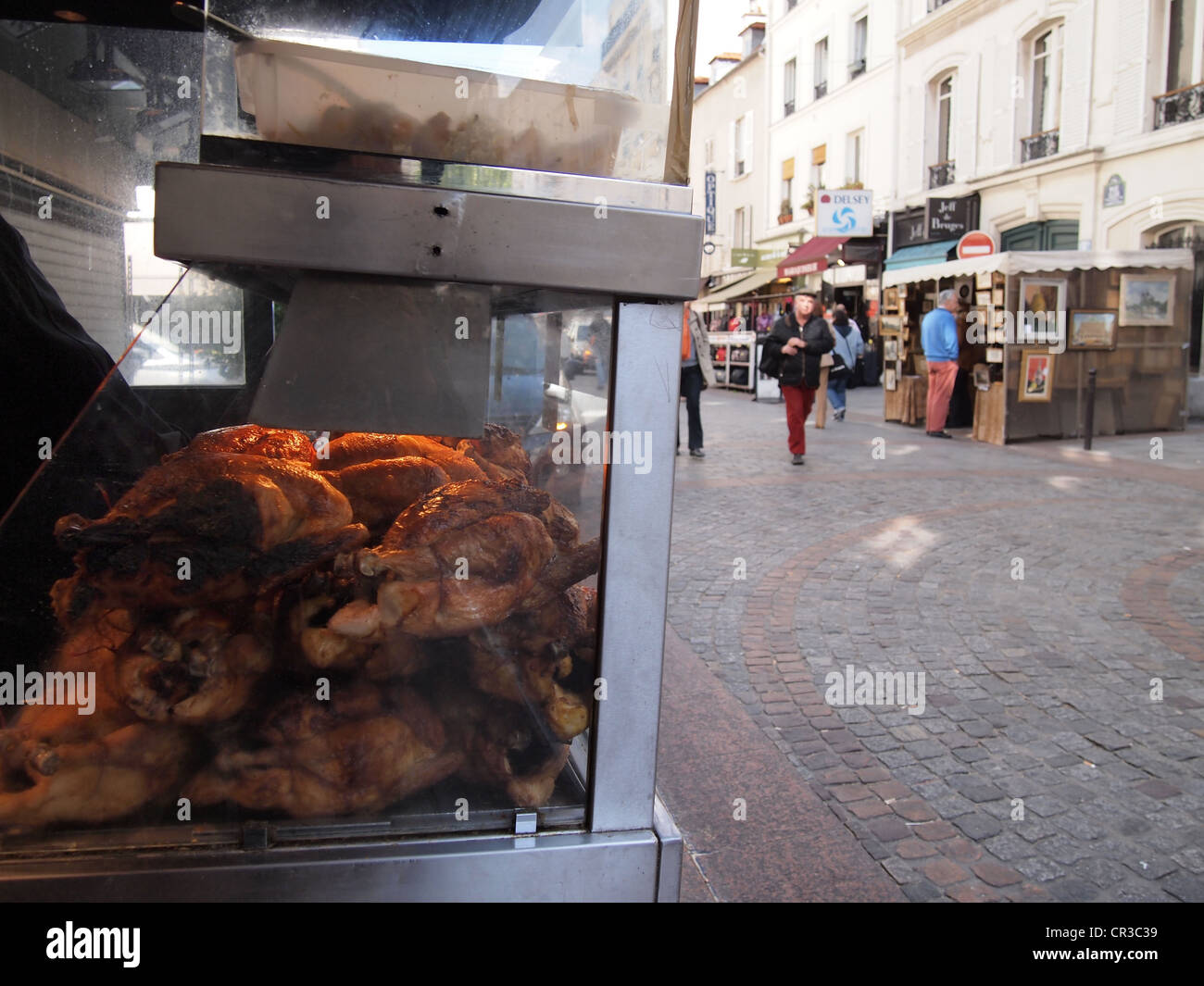 Roasted chickens for sale at a shop on Rue Cler, Paris, France, May 13, 2012, © Katharine Andriotis Stock Photo