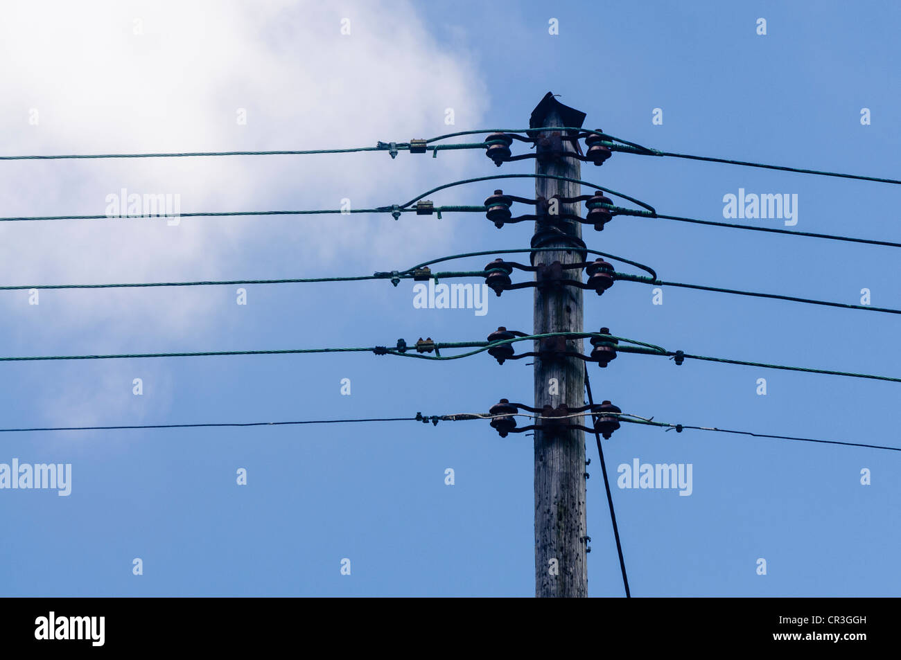 Overhead electricity power lines on a wooden pole Stock Photo