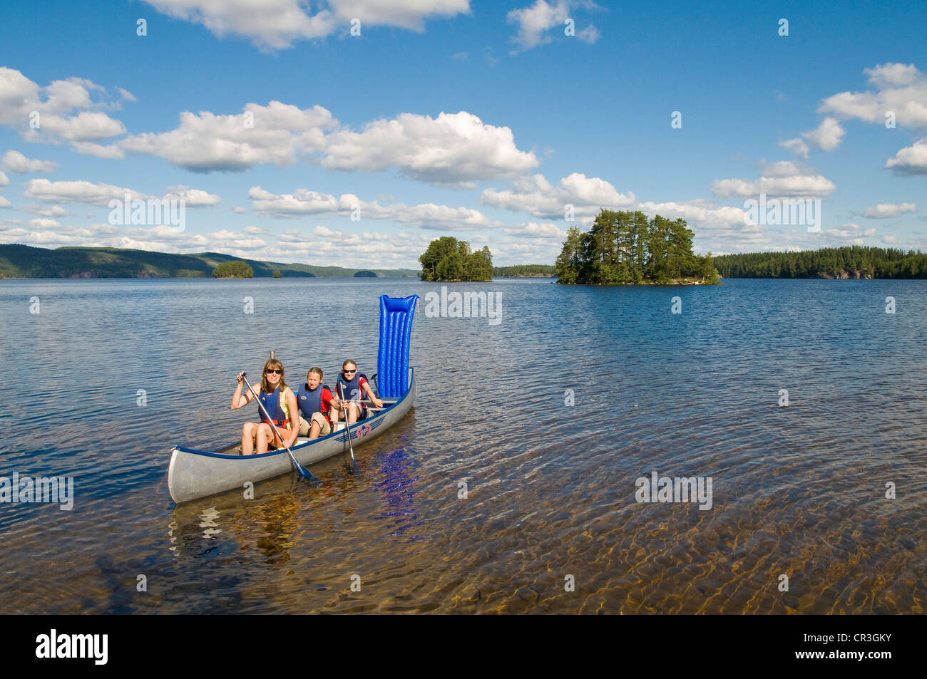 Family canoeing on a lake near Bengtsfors, Dalsland, Sweden, Europe Stock Photo