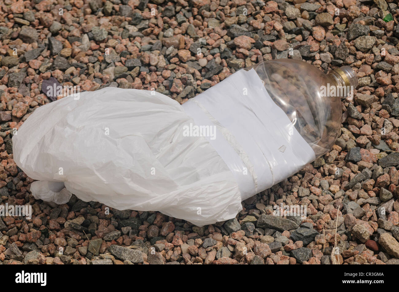 Plastic bag and bottle taped together for glue sniffing Stock Photo