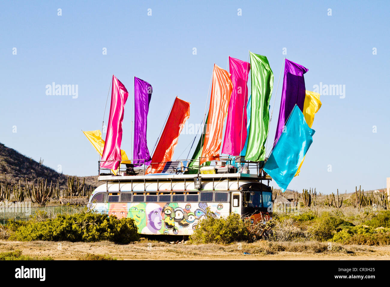 Hippy bus decorated with bright colored (coloured) flags Stock Photo