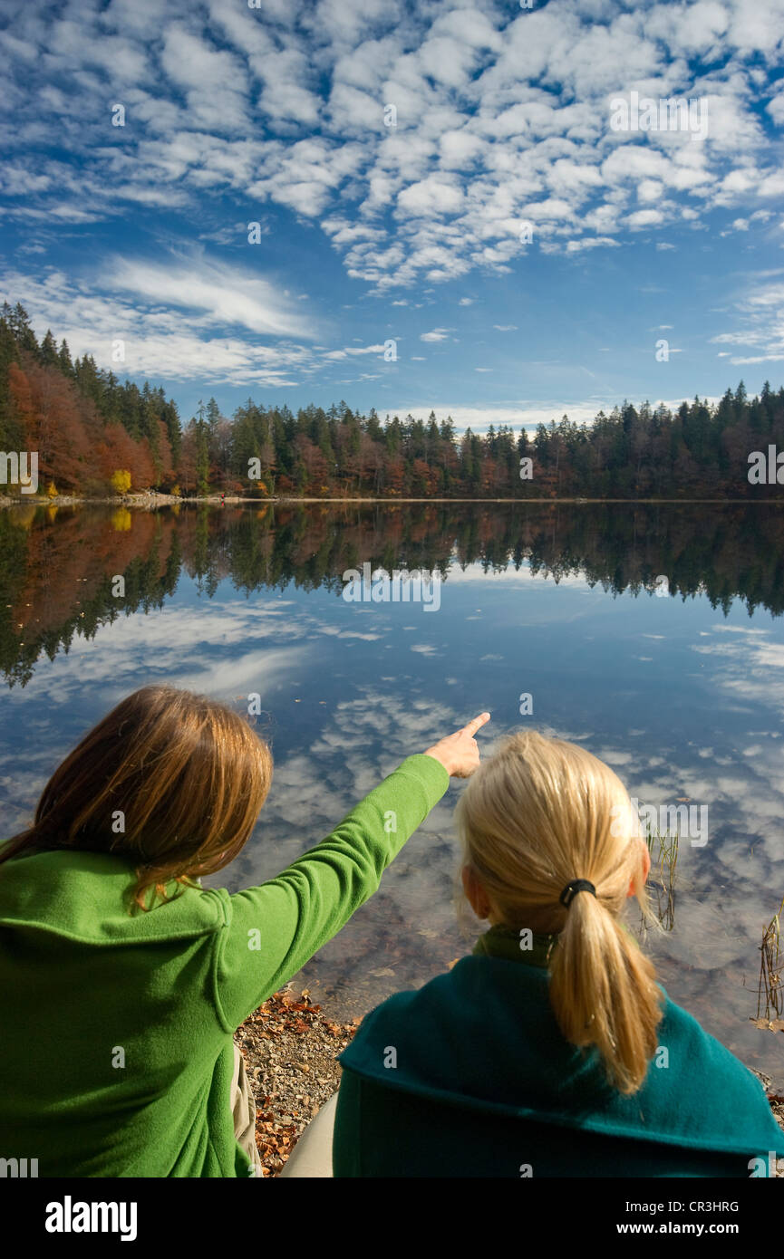 Two hikers at Feldsee lake, at Mt Feldberg, Schwarzwald or Black Forest, Baden-Wuerttemberg, Germany, Europe Stock Photo