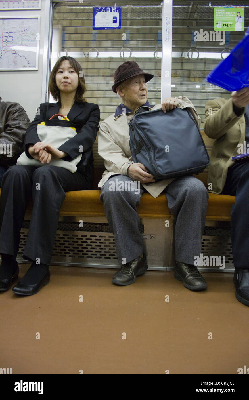 Commuters on a Japanese metro underground train in Osaka, Japan Stock Photo