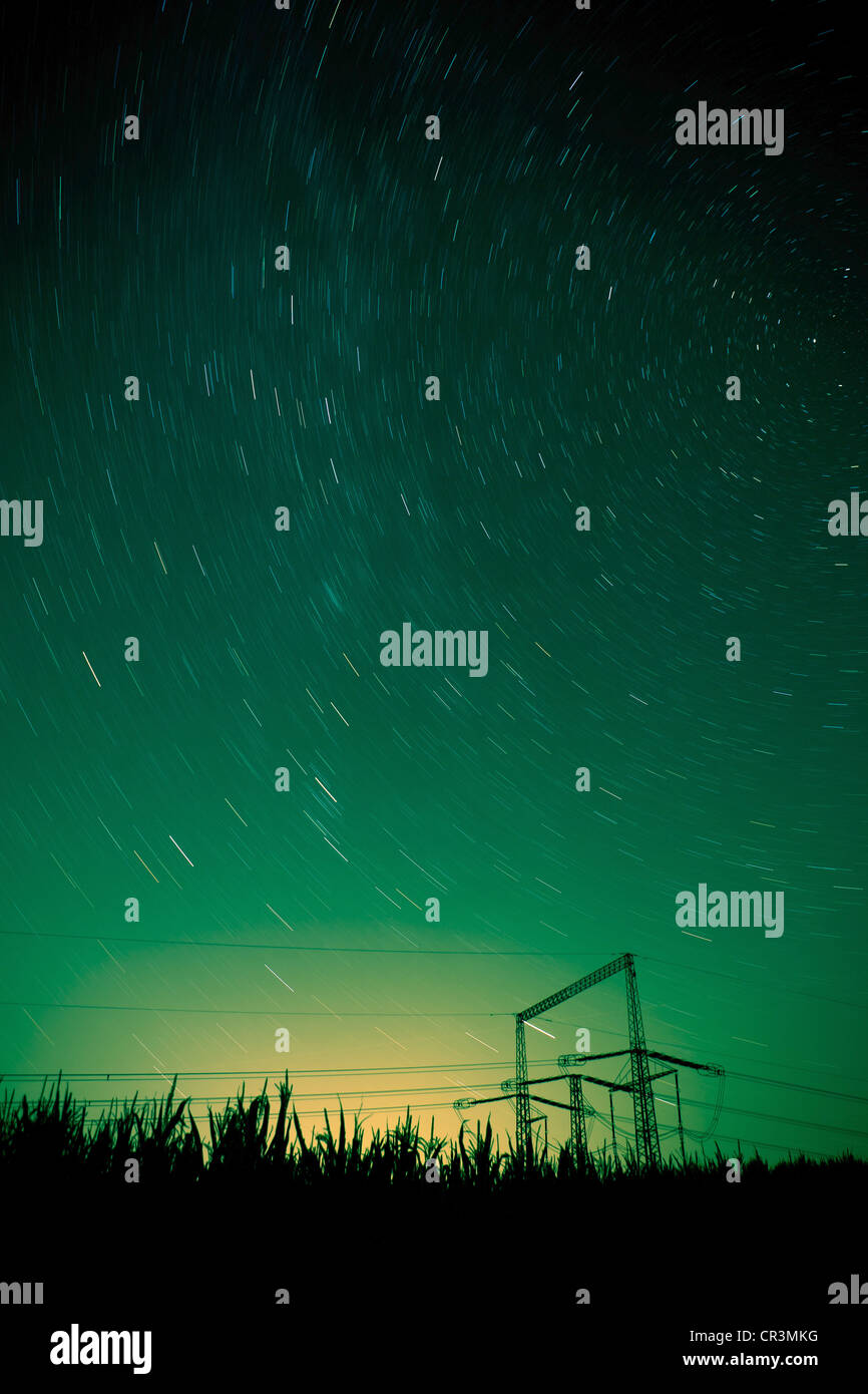 starry night landscape with high voltage poles Stock Photo - Alamy