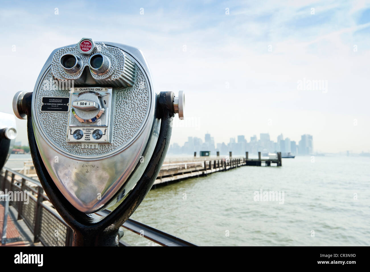 Telescope, Liberty Island and Manhattan skyline, New York, USA Stock Photo