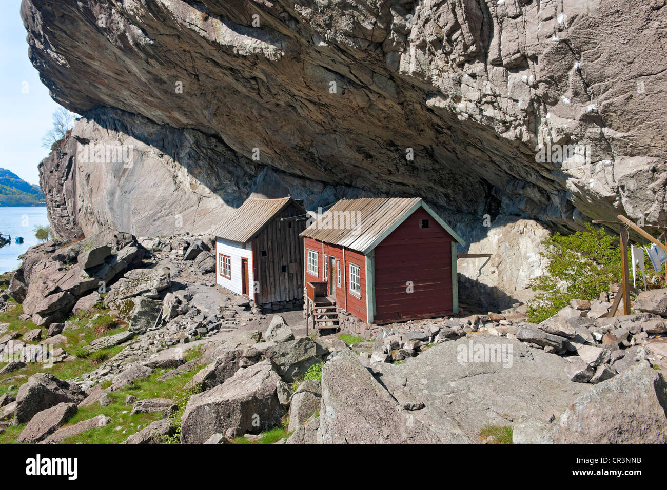 Houses under Helleren mountain ledge, Sokndal, Norway, Europe Stock Photo