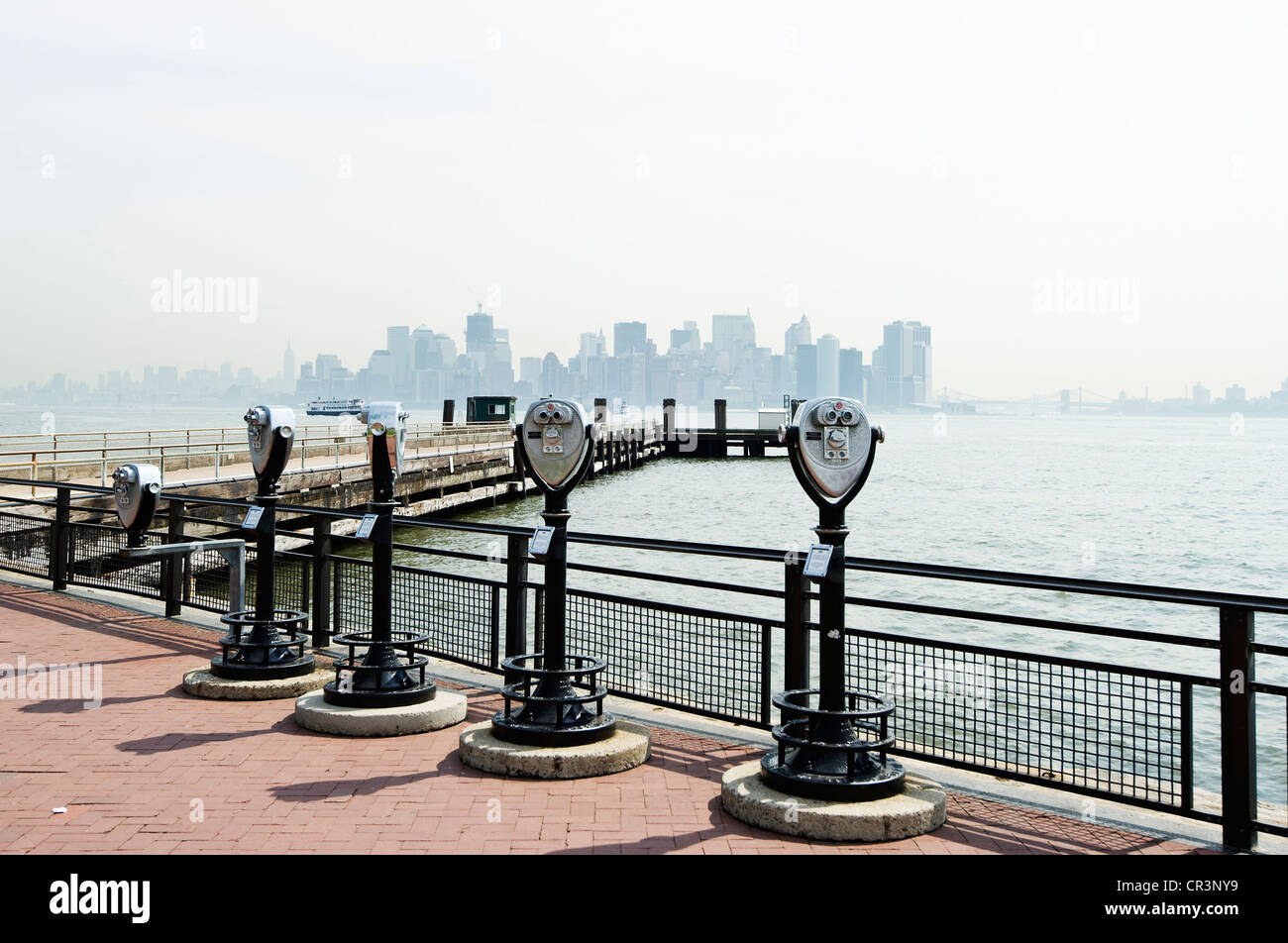 Telescopes on Liberty Island with a view of downtown Manhattan, New York, USA, America Stock Photo