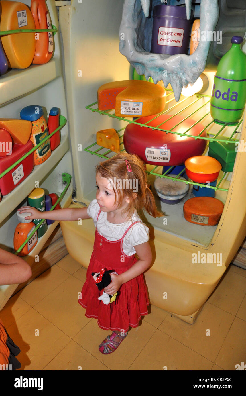 Little girl enjoys exploring Minnie Mouse's refrigerator full of wacky