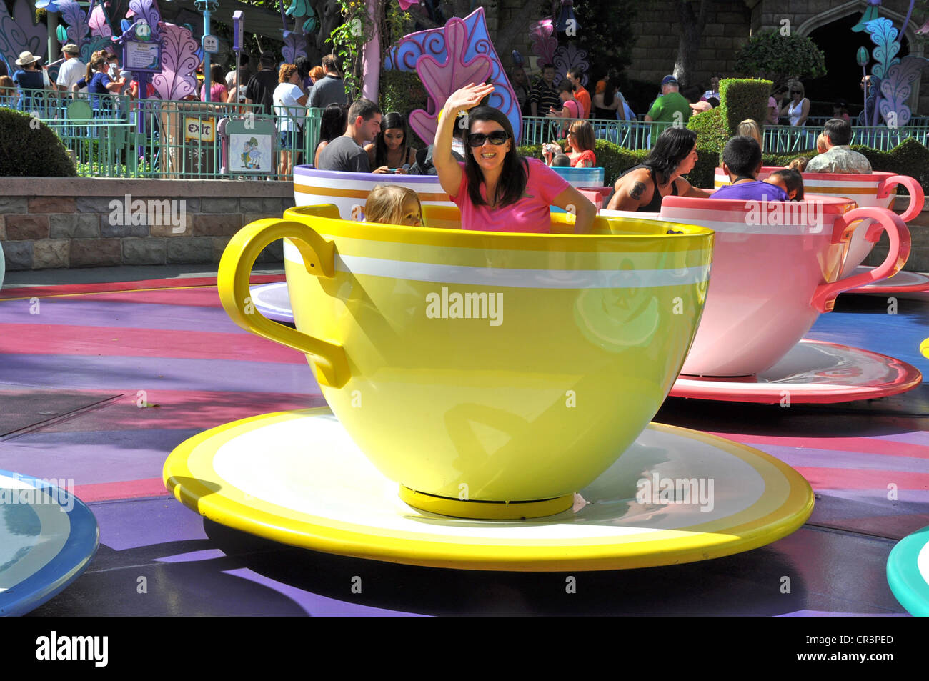 Families having fun on Disneyland's Tea Cups and Saucers attraction in