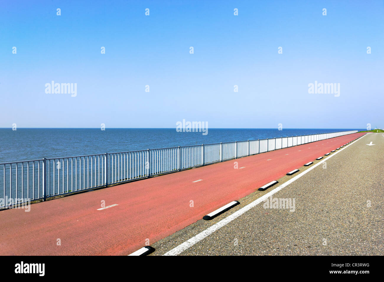 Highway with red asphalt along the sea, Holland, Netherlands, Europe Stock Photo