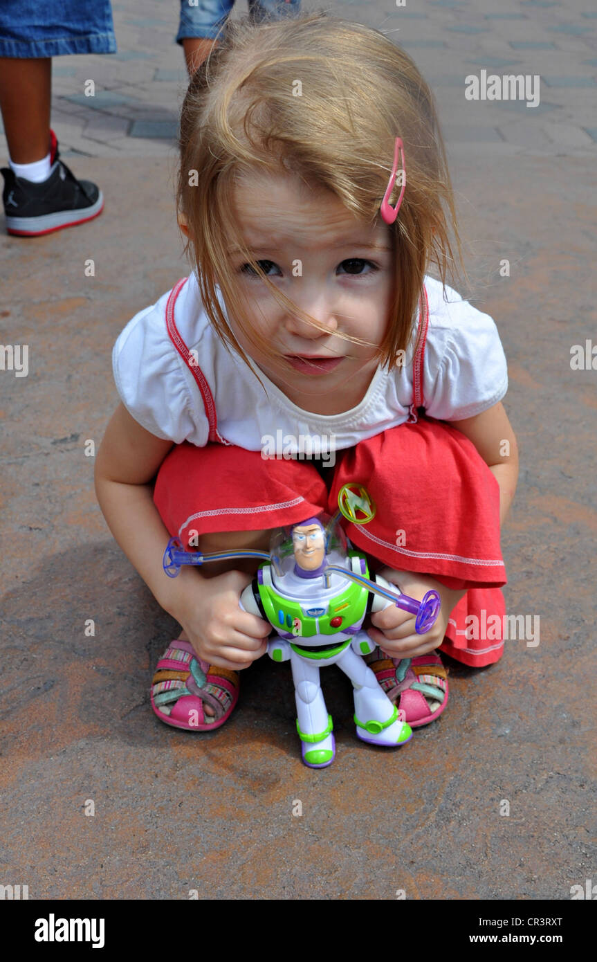 Little girl poses with Buzz Lightyear from the movie 'Toy Story' at Disneyland, Anaheim, California Stock Photo