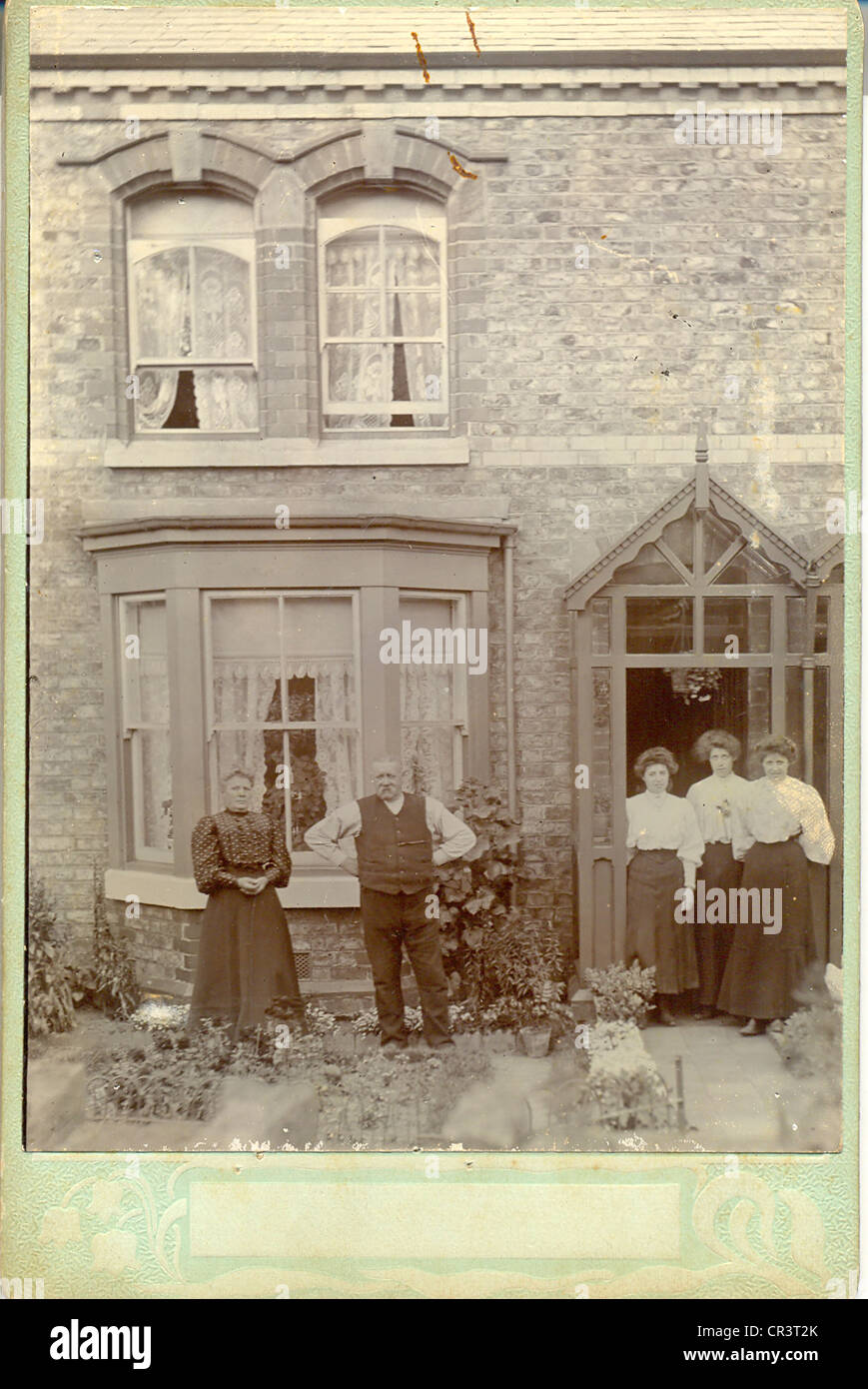 Cabinet photograph family in front of their terrace house Stock Photo
