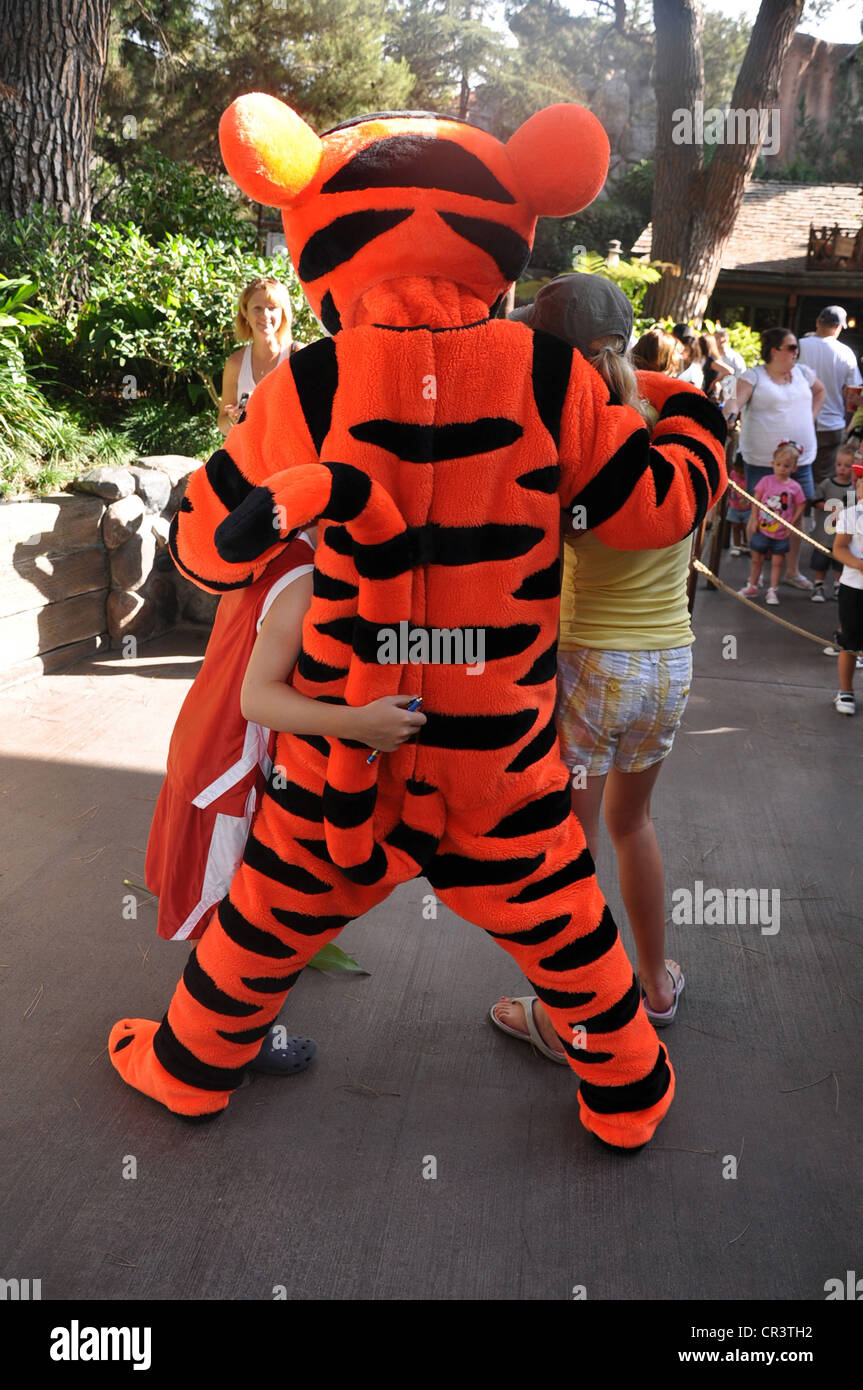 The Tigger character from the Many Adventures of Winnie the Pooh attraction hugs kids at Disneyland Park, Anaheim, California Stock Photo