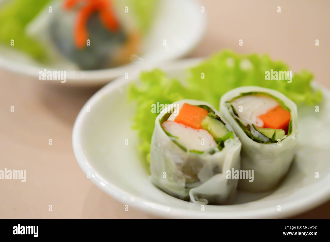 noodle roll served with fresh vegetable on white dish Stock Photo