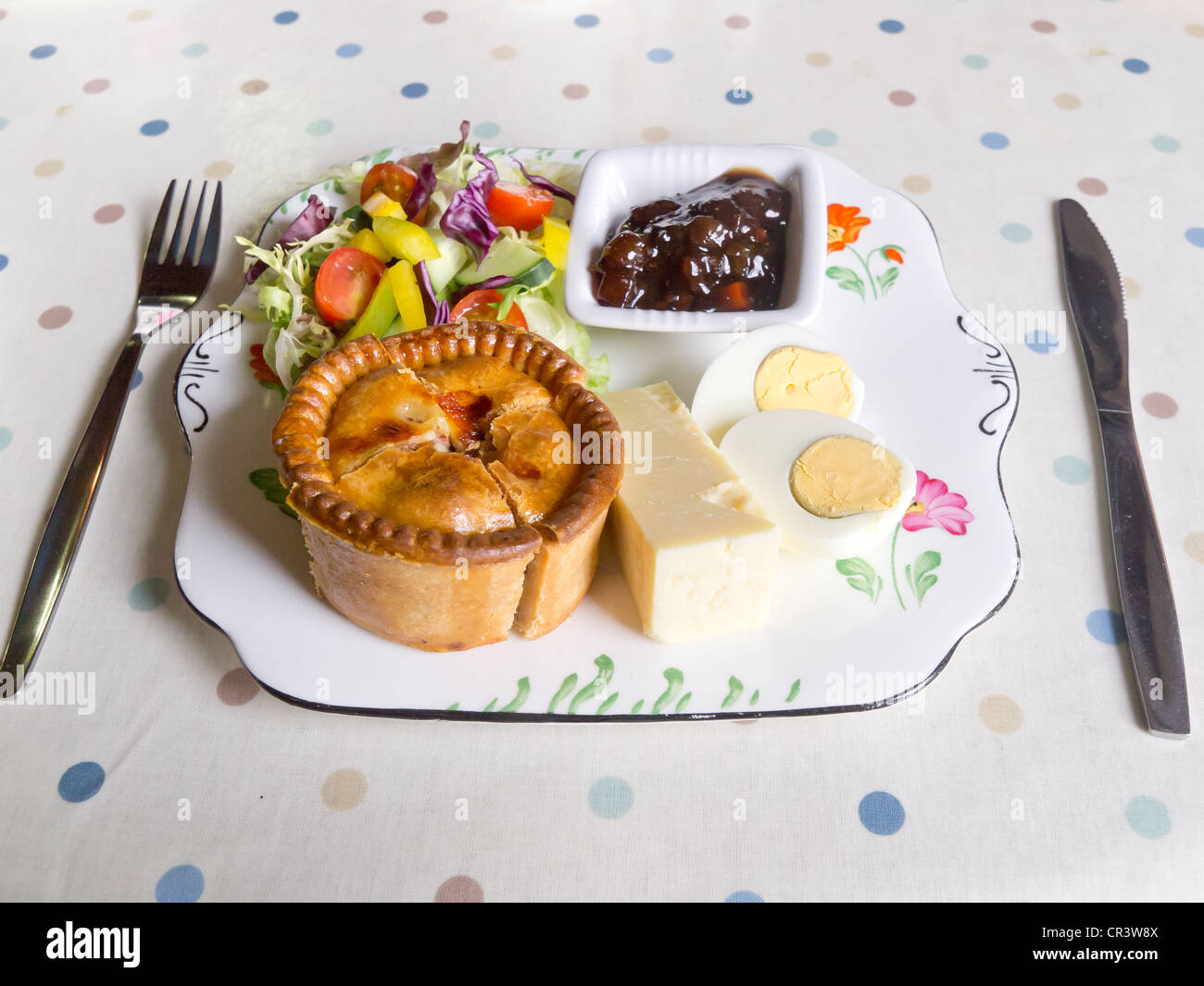 A "Ploughman's Lunch" of Pork Pie Cheese Boiled Egg Salad and Pickle in