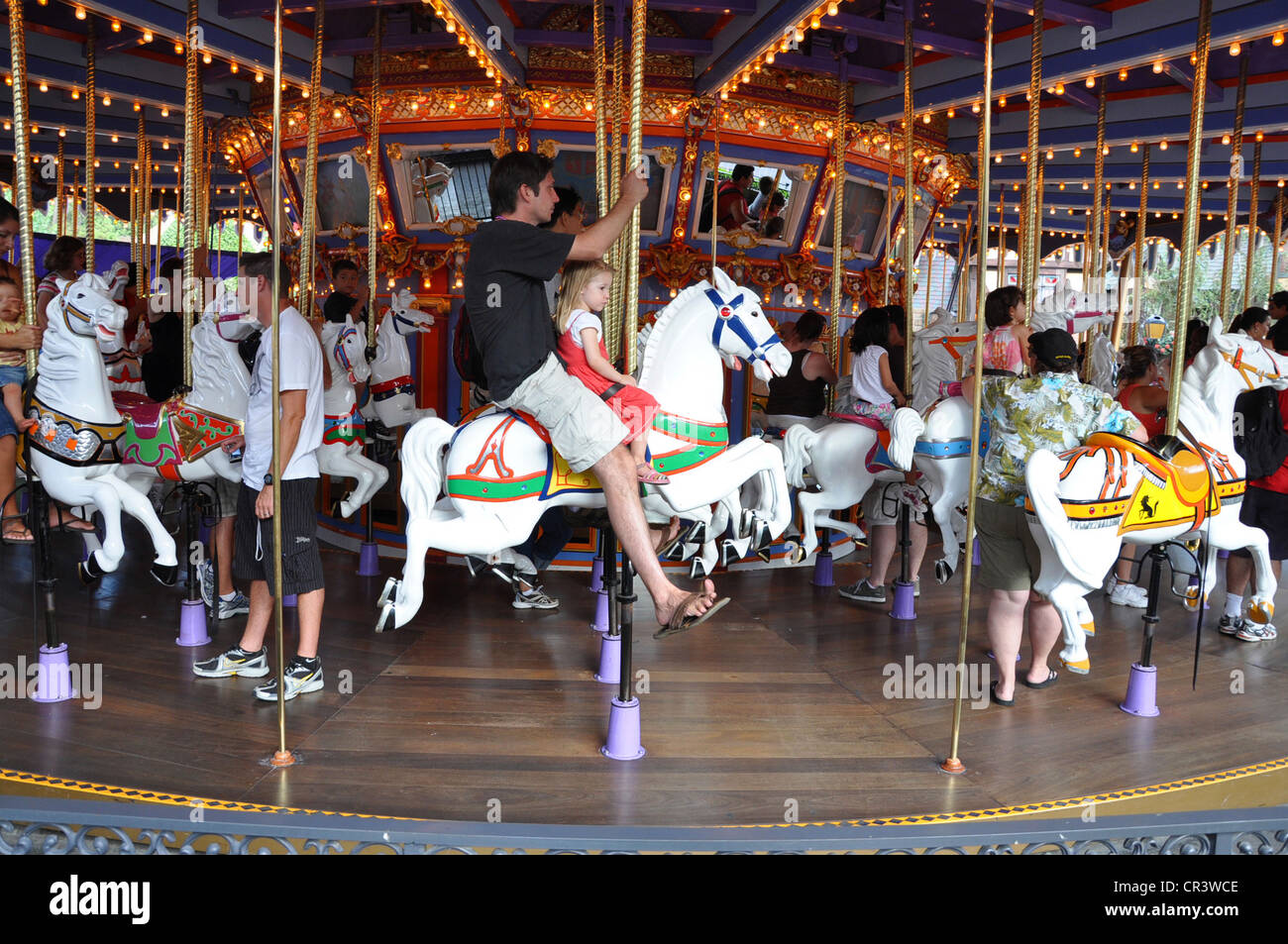 Families enjoy riding ornate white horses at King Arthur's Carousel