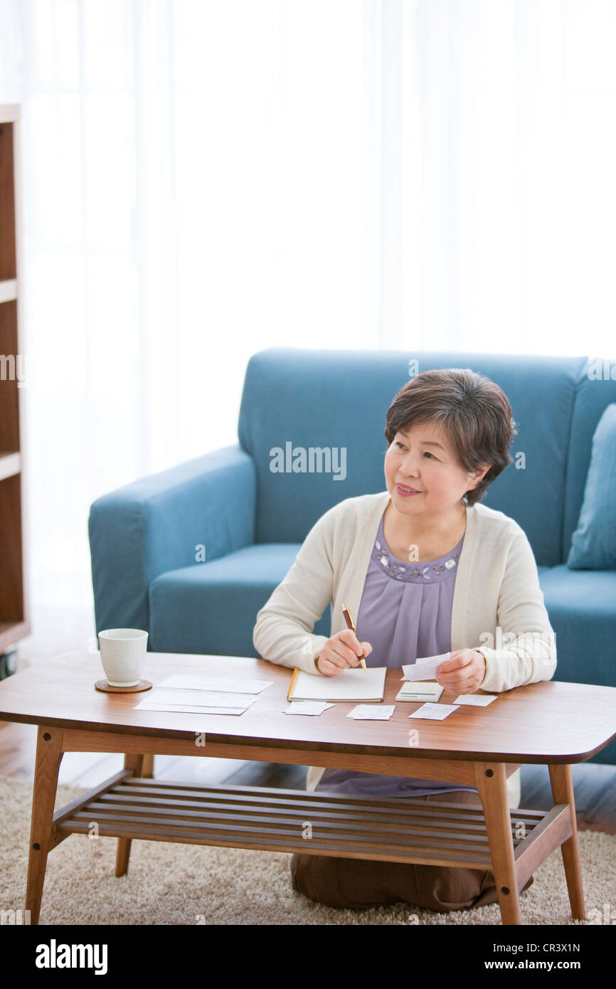 Mature Woman In Living Room Stock Photo - Alamy