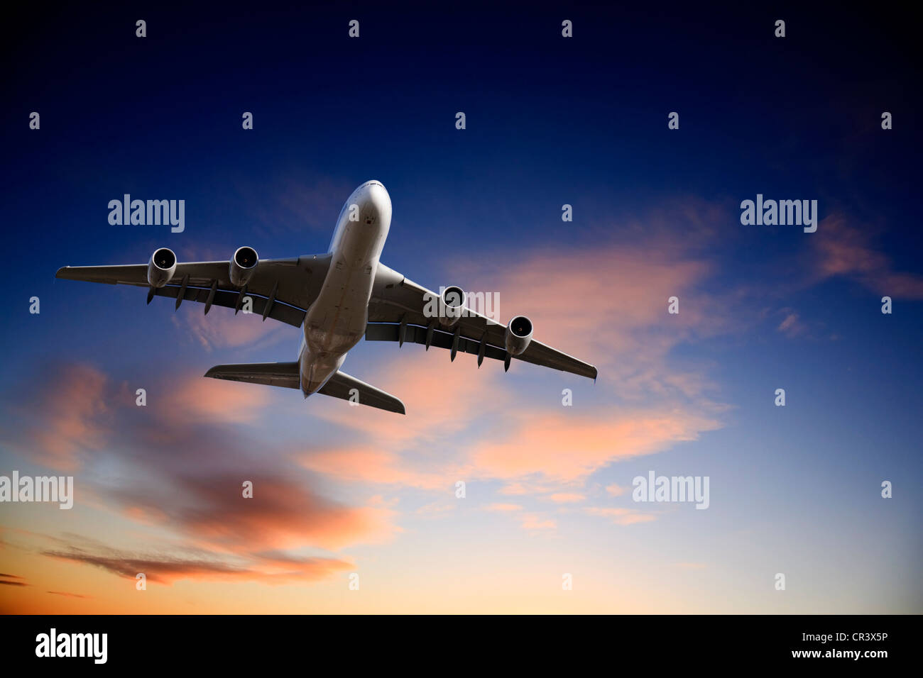 Airbus A380 jet aeroplane taking off in bright dramatic twilight sunset moody sky. Stock Photo