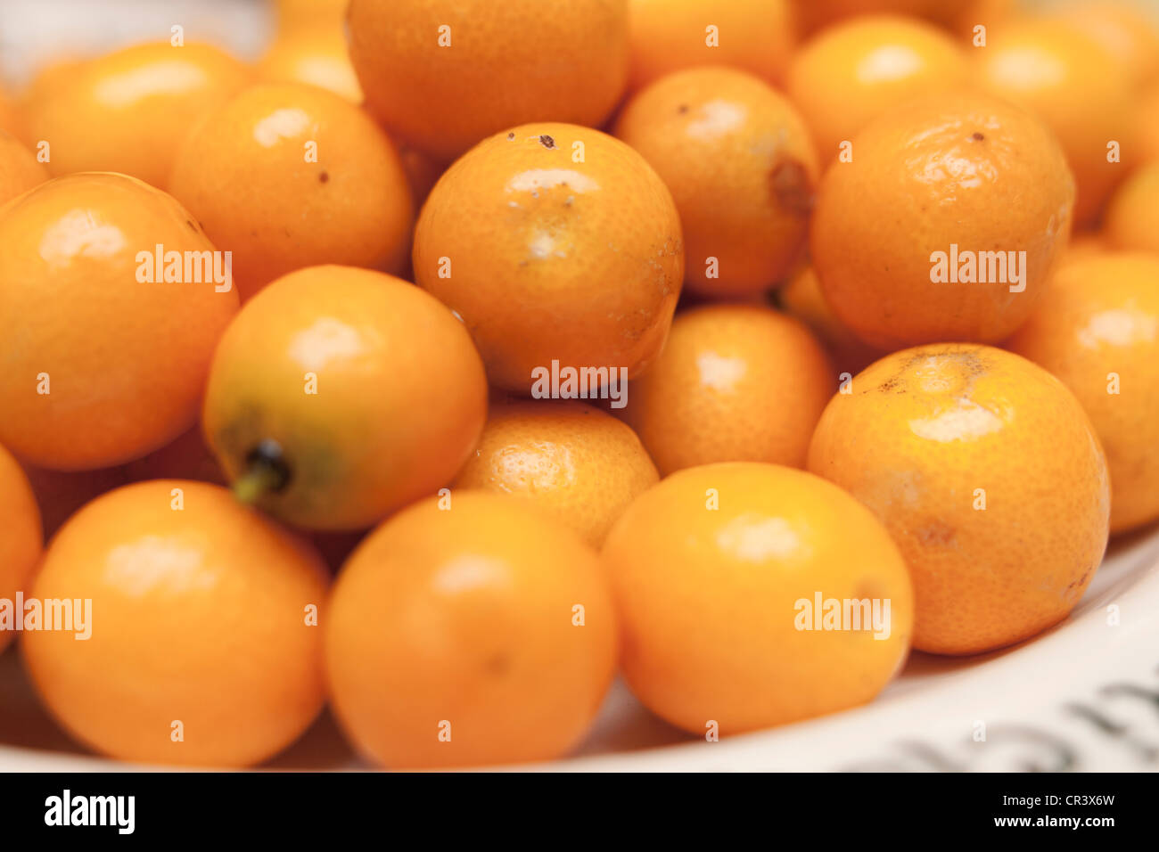 A bowl full of orange kumquat's Stock Photo
