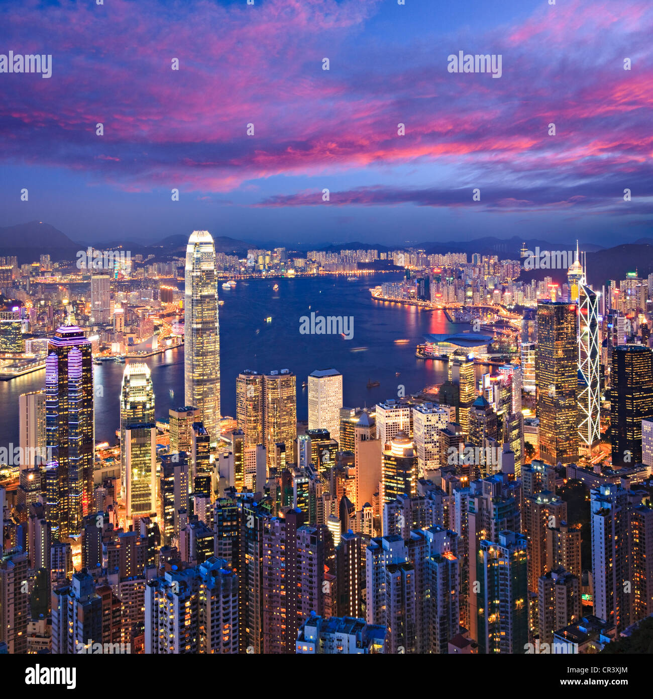 Hong Kong skyline illuminated at twilight, square format. Stock Photo