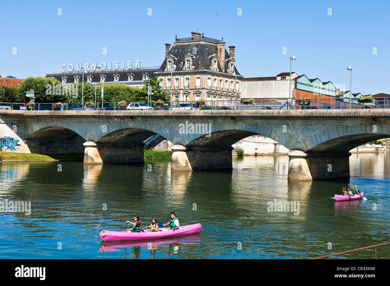 France, Charente, Jarmac, canoe on Charente River and Maison Courvoisier cognac (brandy) wine warehouse Stock Photo