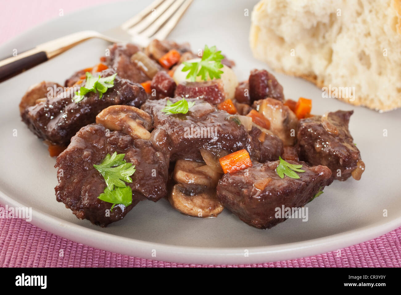 Classic beef bourguignon served with crusty bread. Stock Photo