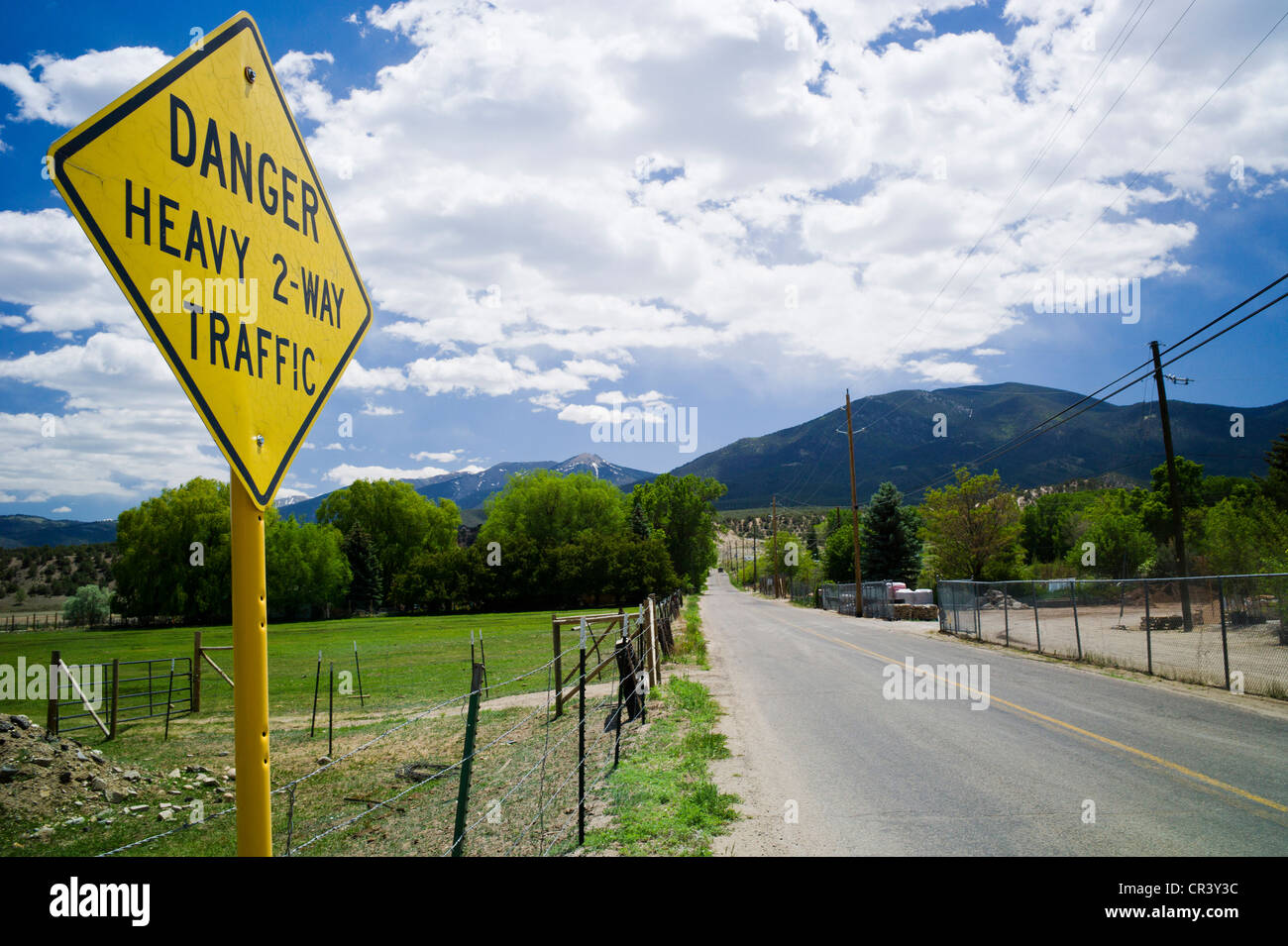 Humorous sign reads 'Danger, Heavy 2-Way Traffic', on rural County Rd 107 near Sallida, Colorado, USA Stock Photo