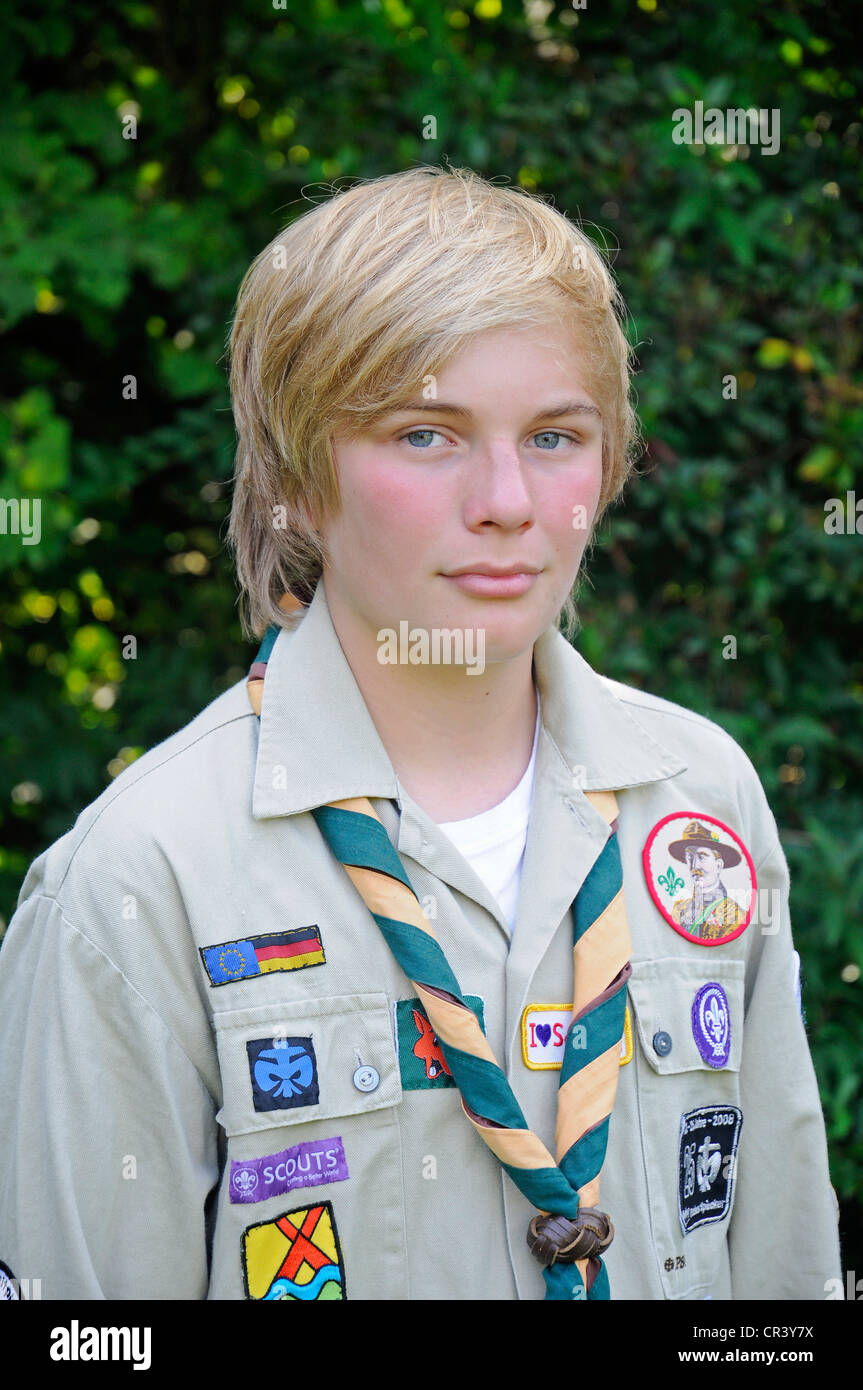 Boy, 13, wearing a Scouts uniform with badges, neckerchief