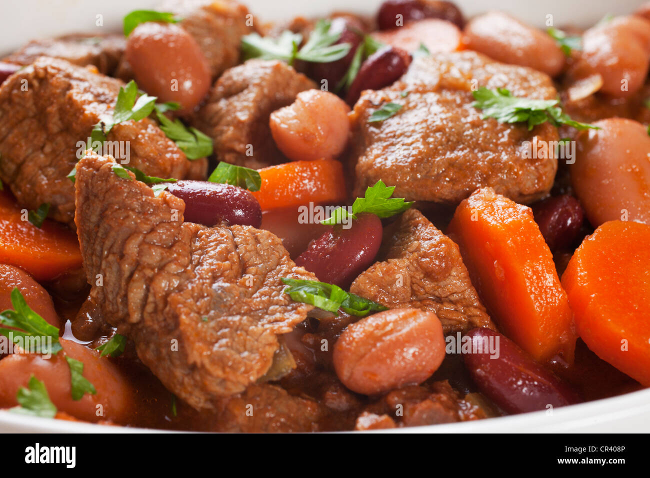 A simple bowl of stew with carrots and beans. Stock Photo