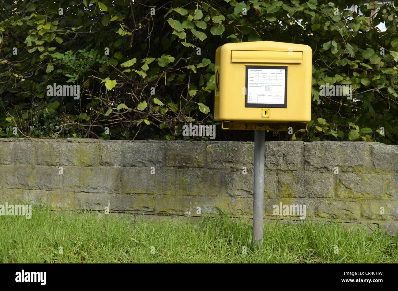 Yellow mailbox of Deutsche Post, German postal service, daily collection, between Dorsten and Gelsenkirchen, Ruhr Area Stock Photo