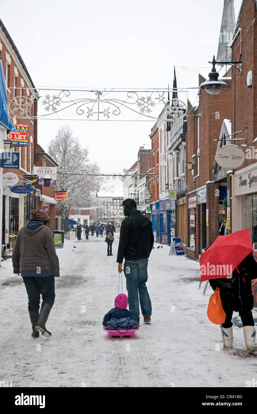 Market Street Lichfield with winter snow Christmas decorations and man