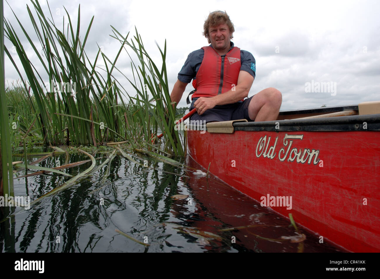Paddling a Canadian canoe on the River Waveney on the Norfolk Suffolk