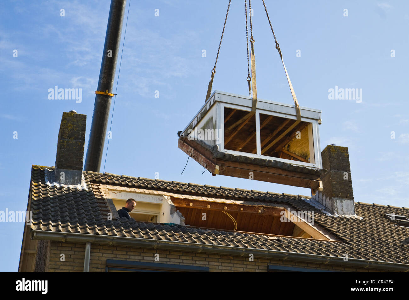Old dormer-window is lifted and removed Stock Photo