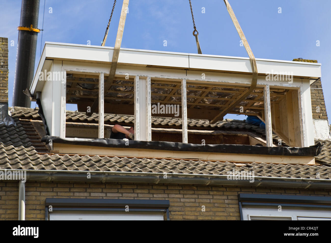 Placing the new dormer-windows exactly right on the roof Stock Photo