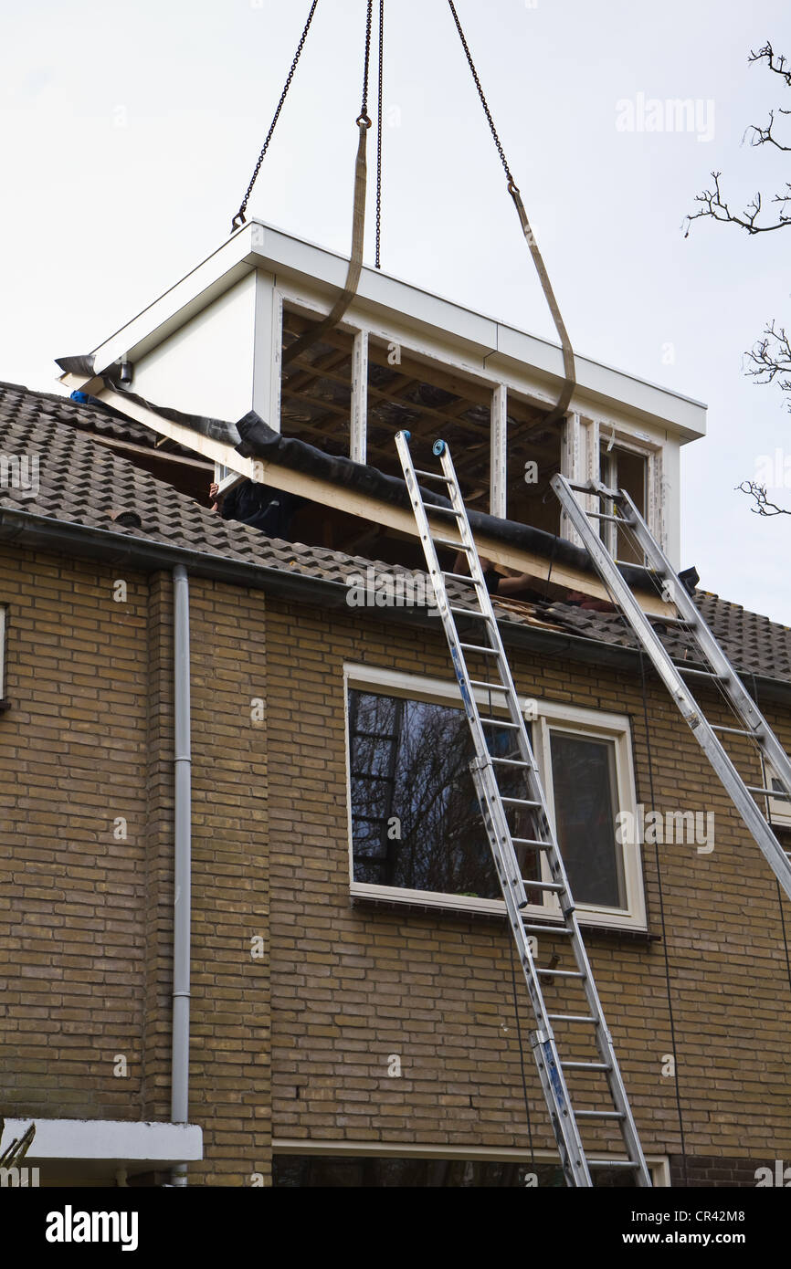 Placing new and bigger dormer-window on front side of house Stock Photo