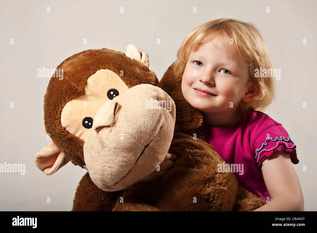 Girl, 5, with a stuffed monkey Stock Photo