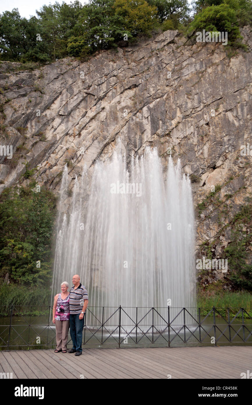 A couple pose for a photograph in front of a large fountain in Durbuy, Wallonia, Belgium. Stock Photo