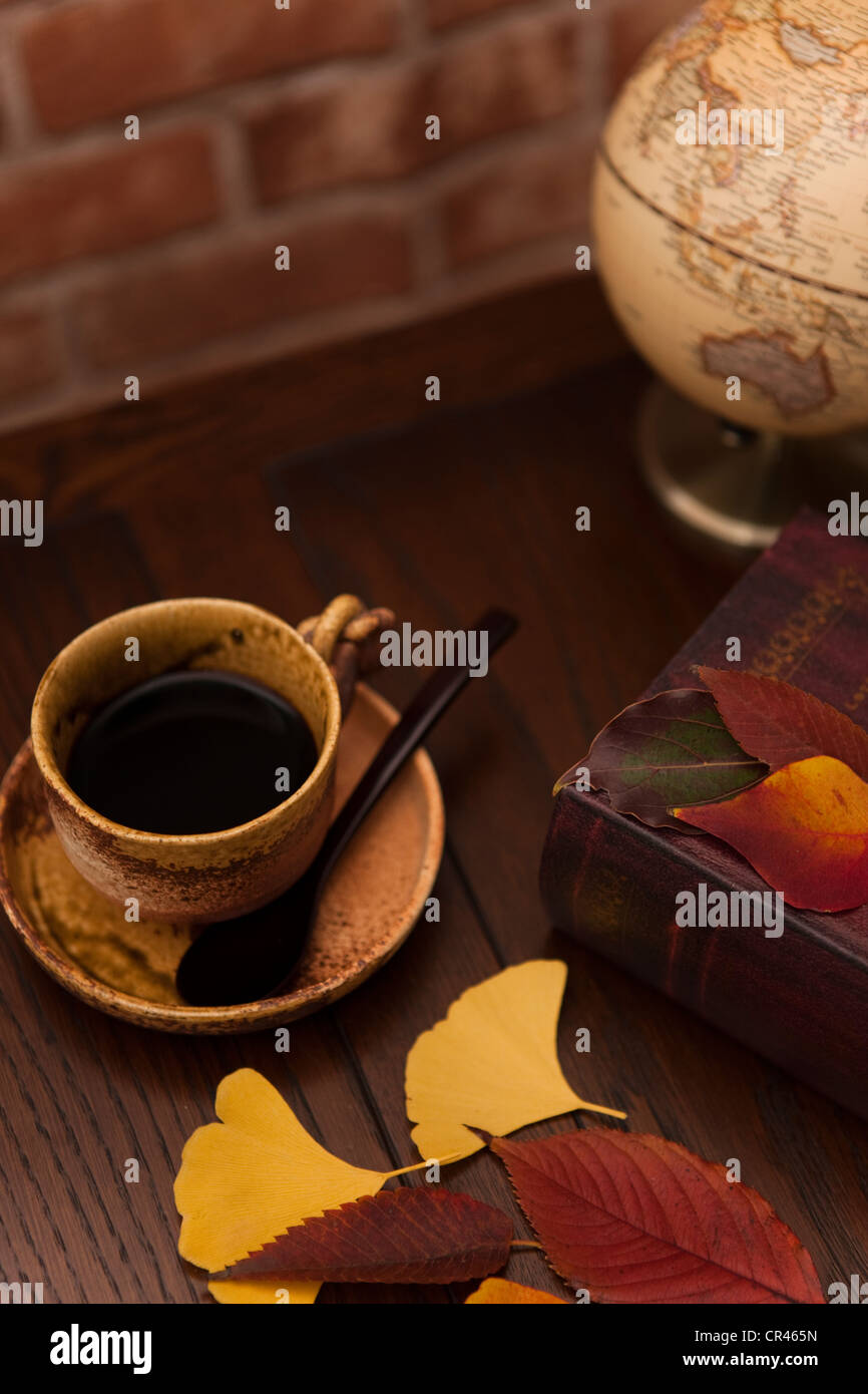 Coffee Cup and Autumnal Leaves Stock Photo - Alamy