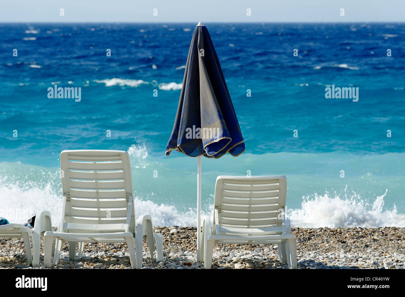 Deck chairs and parasol on the beach, Kokkari, Samos island, southern Sporades, Aegean sea, Greece, Europe Stock Photo