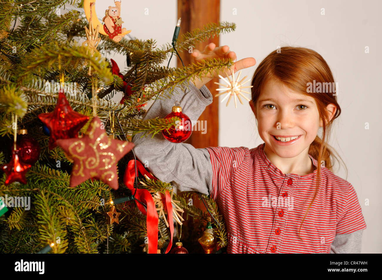 Girl with a Christmas tree Stock Photo - Alamy