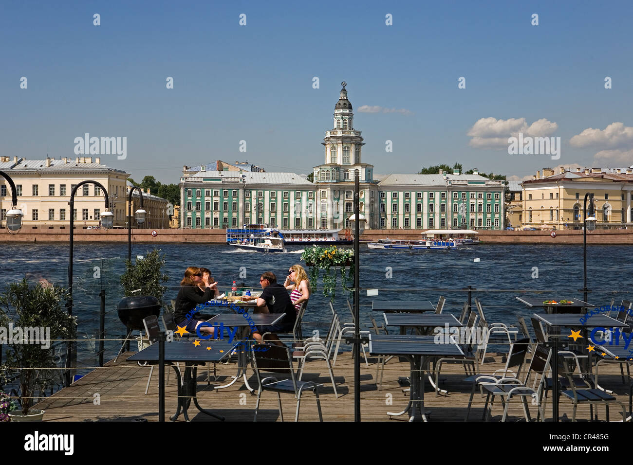 Russia, St Petersburg, UNESCO World Heritage, cafe terrace in front of Neva River and Kuntskamera (Anthropology and Ethnology Stock Photo
