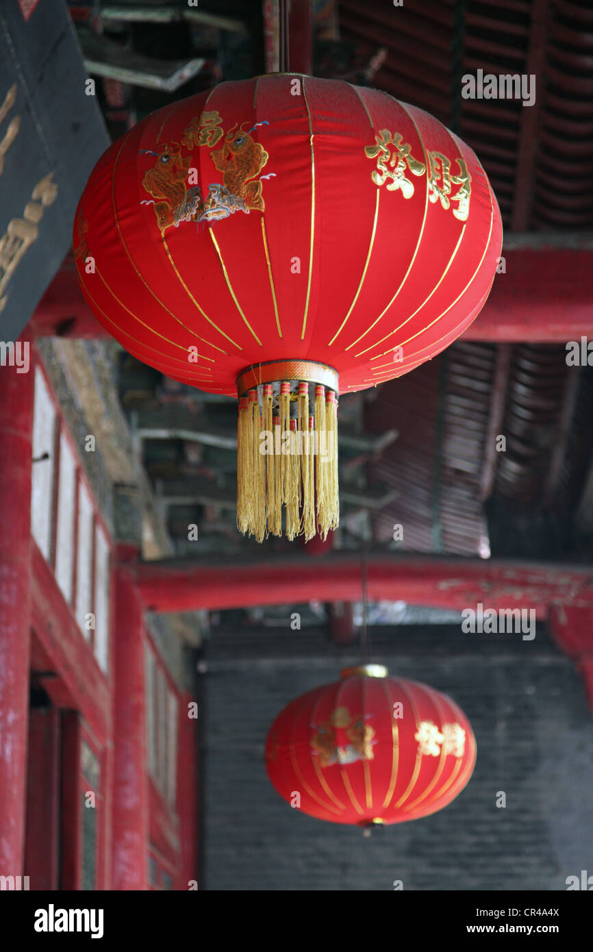 It's a photo of red Chinese lanterns hanged to the ceiling in a temple ...
