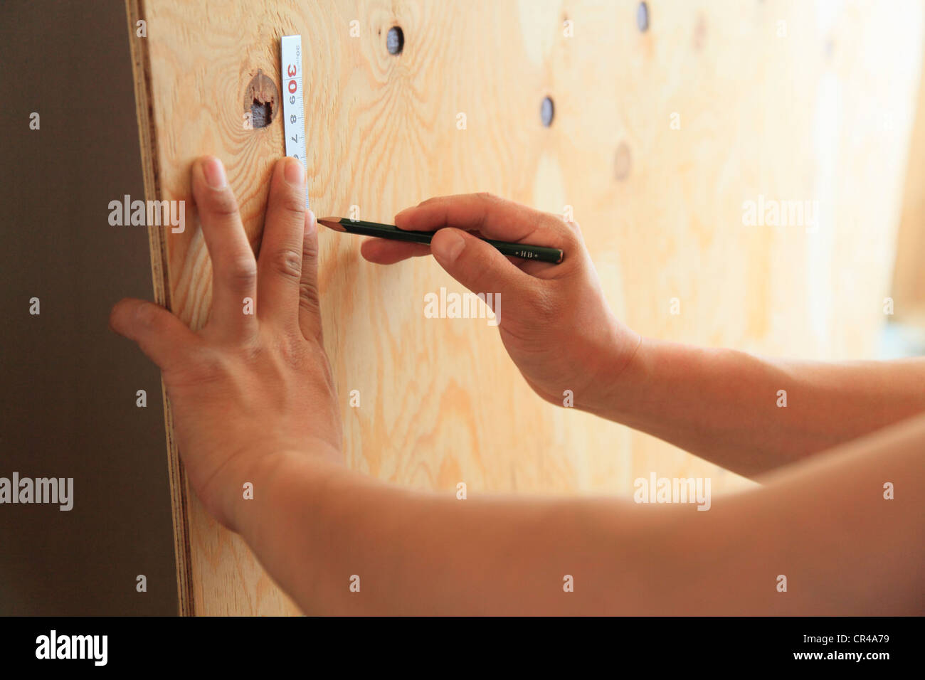 Carpenter Measuring with Ruler Stock Photo - Alamy