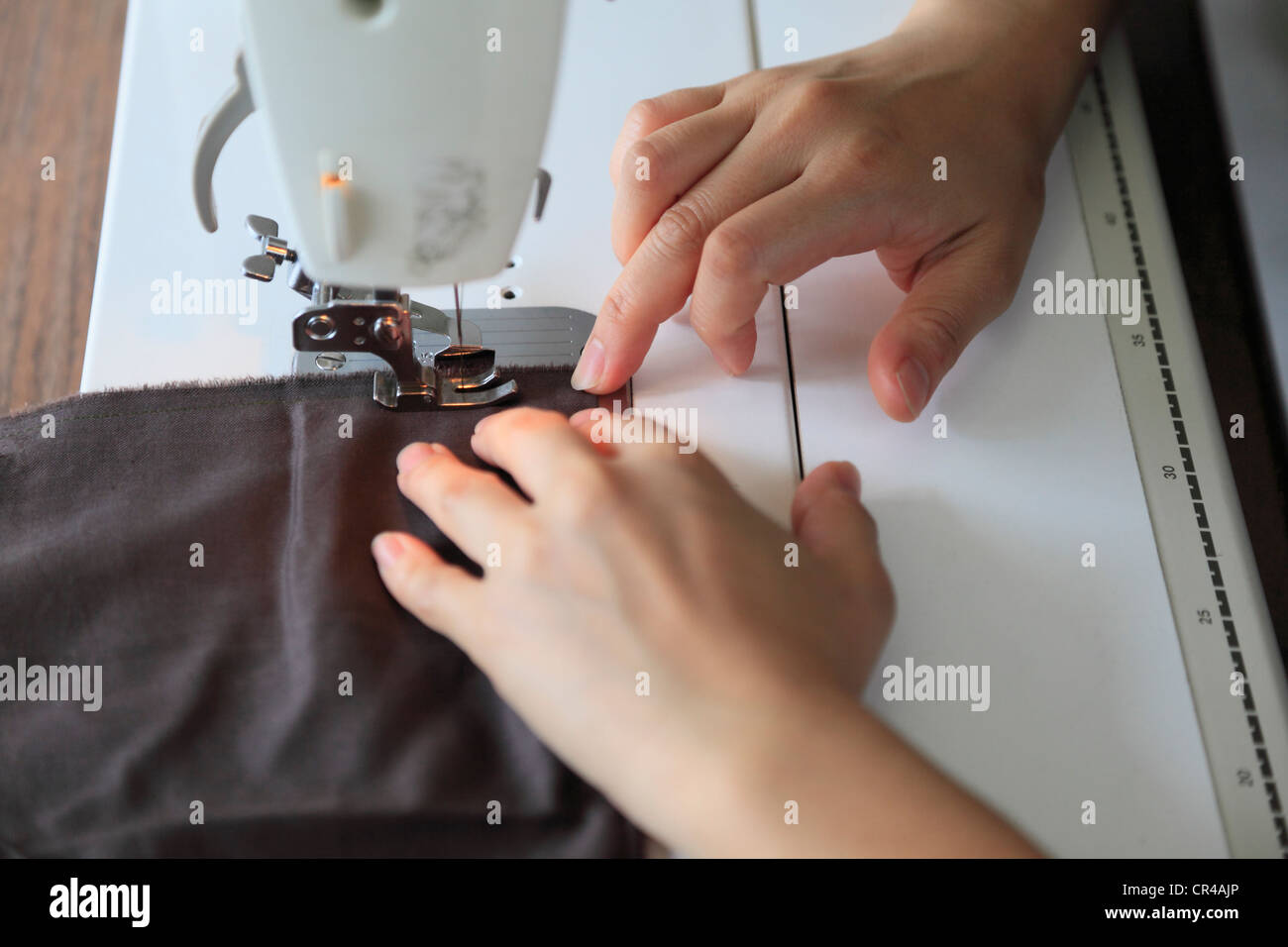 Dressmaker Sewing Cloth on Sewing Machine Stock Photo Alamy