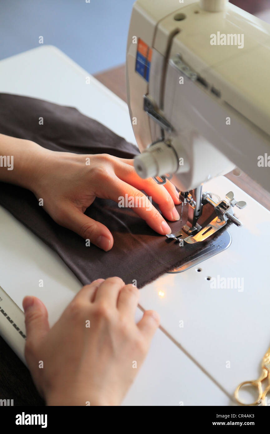Dressmaker Sewing Cloth on Sewing Machine Stock Photo Alamy