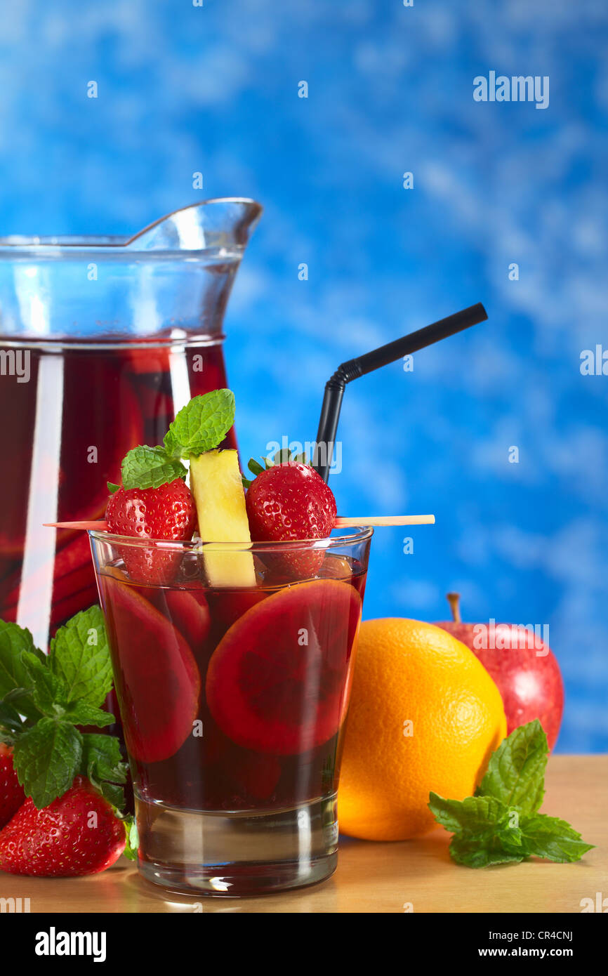 Refreshing red wine punch called sangria mixed with orange, apple and mango, garnished with